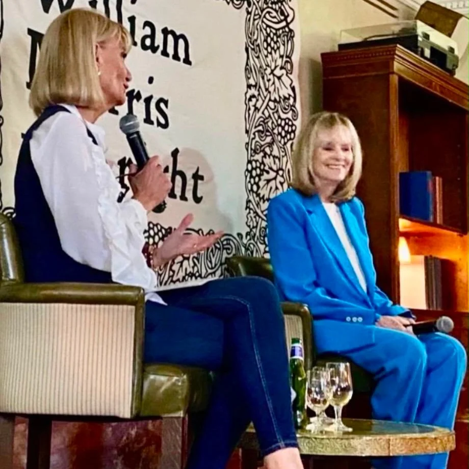 Two guests in conversation with a William Morris was right banner behind them at a Prime Time Reset live event