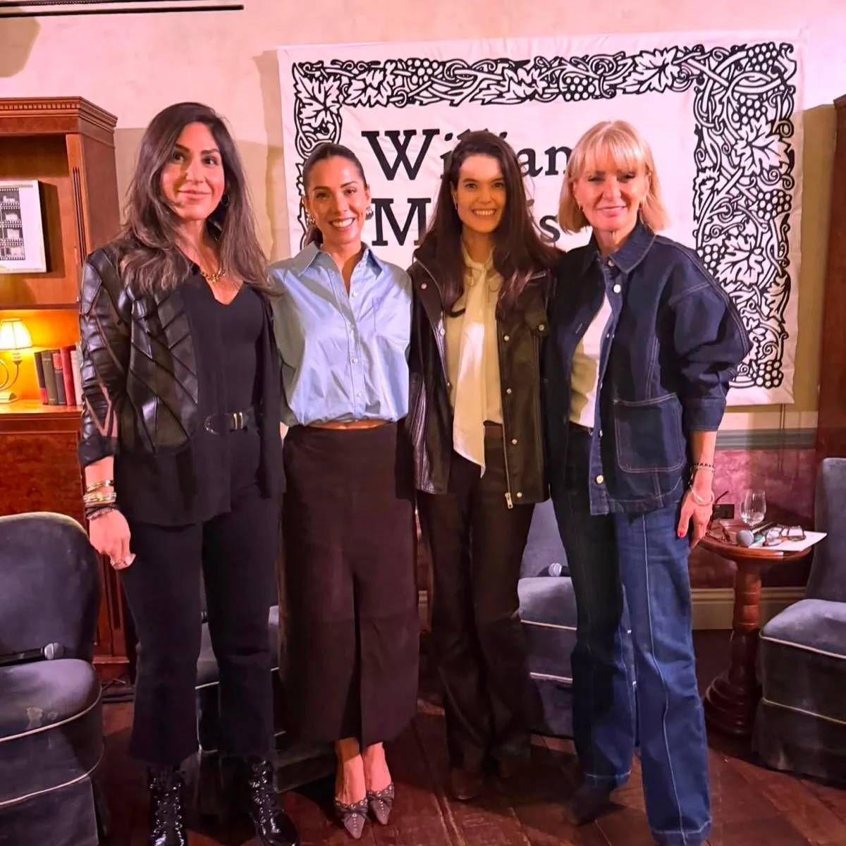 Four guests posing together in front of a William Morris was right banner at a Prime Time Reset live event