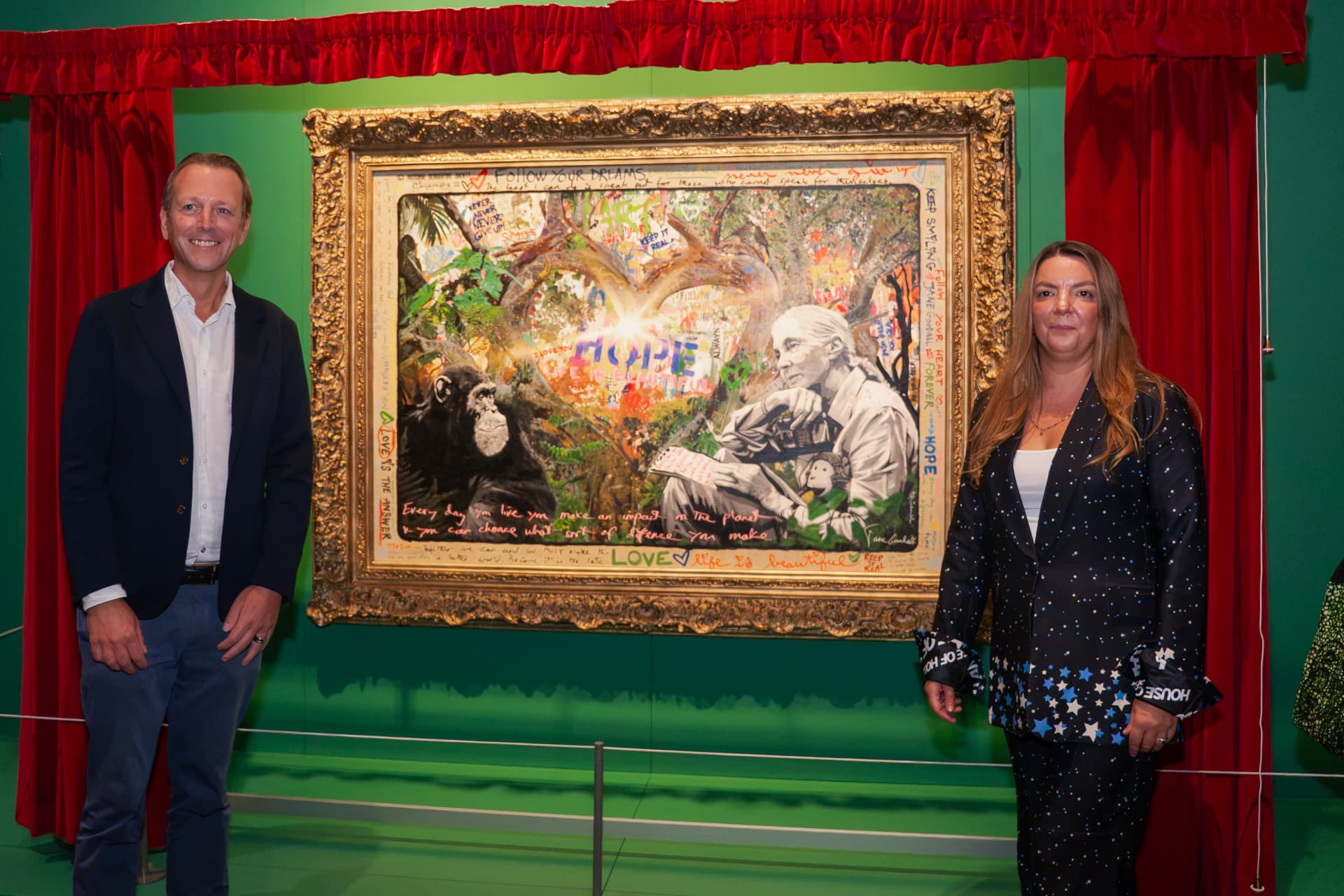 Two guests in front of the Mr Brainwash portrait of Jane Goodall at the Science Museum